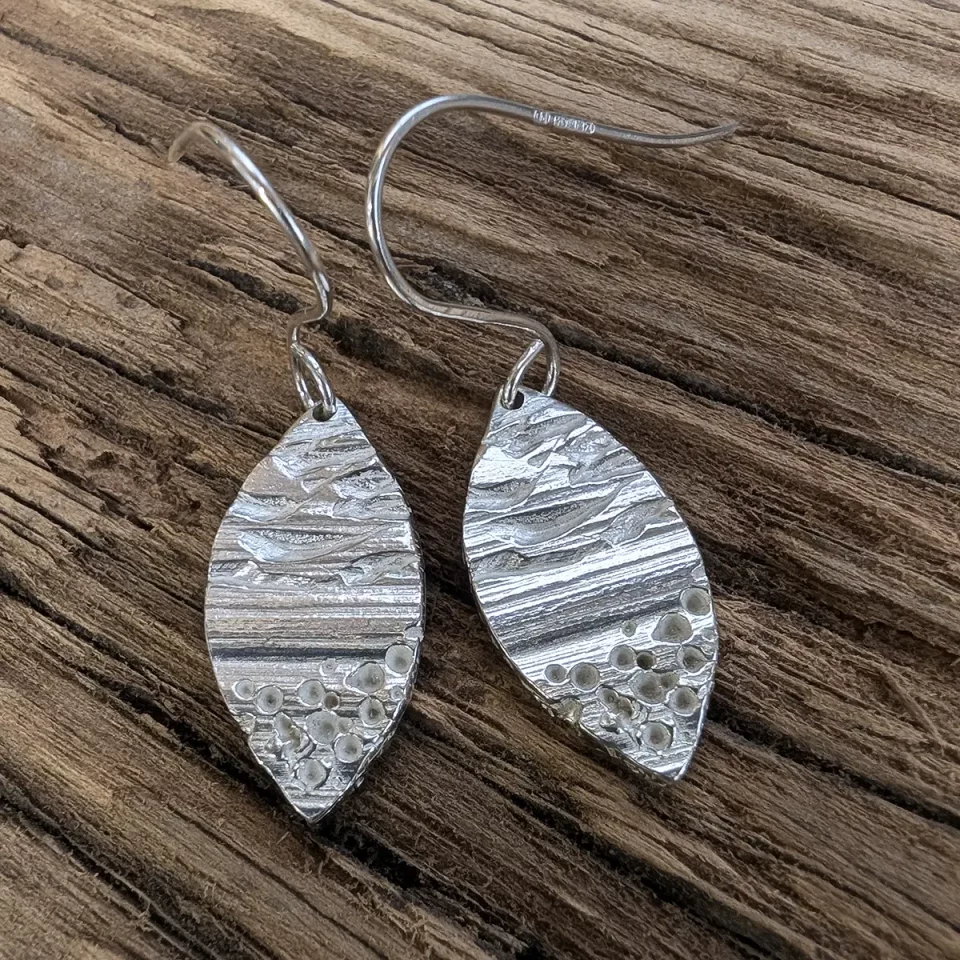 leaf drop earrings on wood